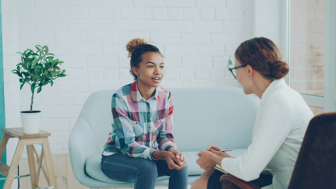 Counselor warmly listening to a client during a supportive conversation