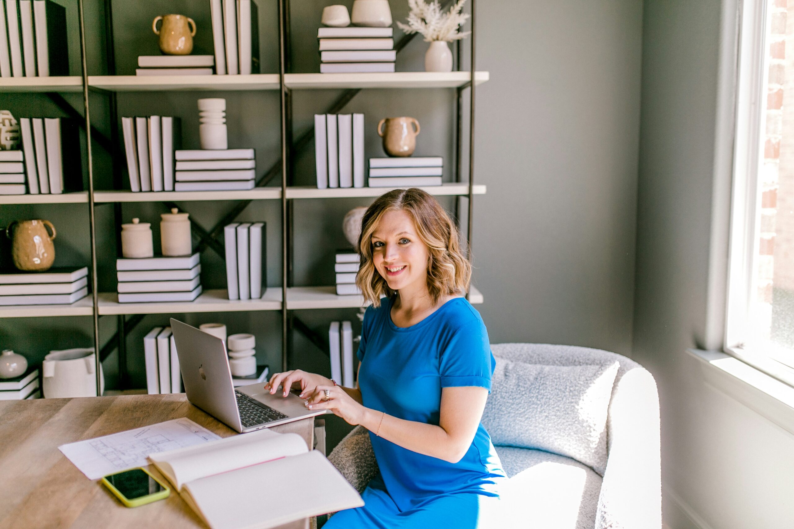 Smiling professional working at a laptop, ready for good news